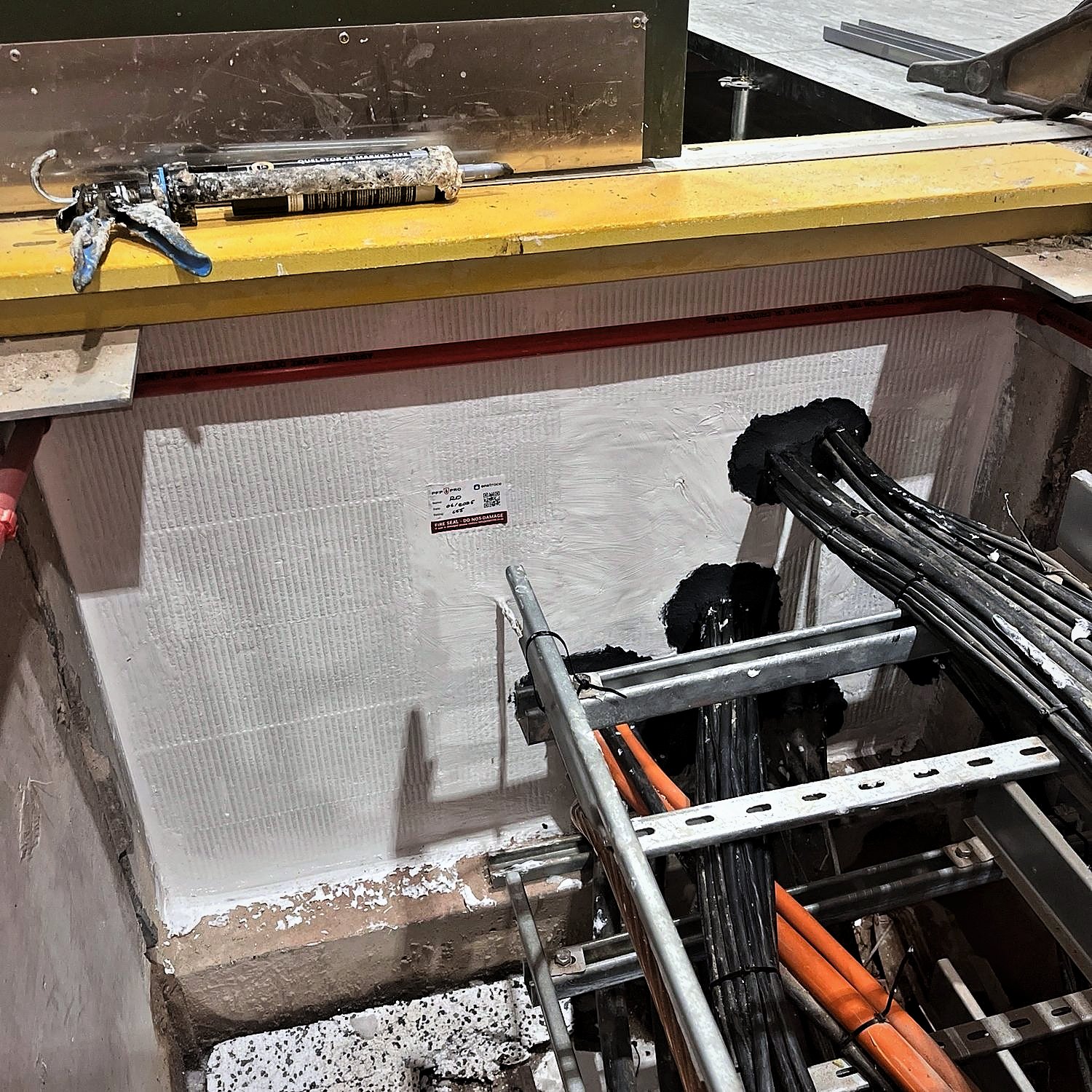 Fire-stopped and labelled cable penetrations in a cable trench