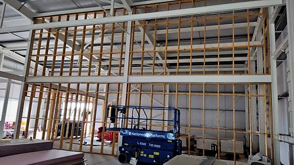 Full-height stud framing ready for boarding