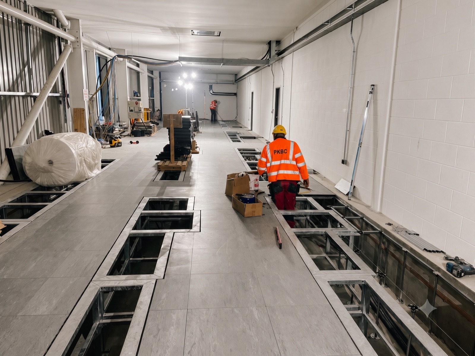Raised access floor and open service bays inside the Beatrice substation building