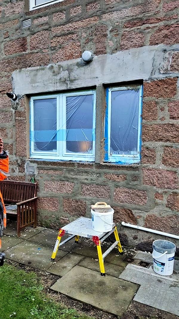 Replacement windows with protective film installed in a granite wall