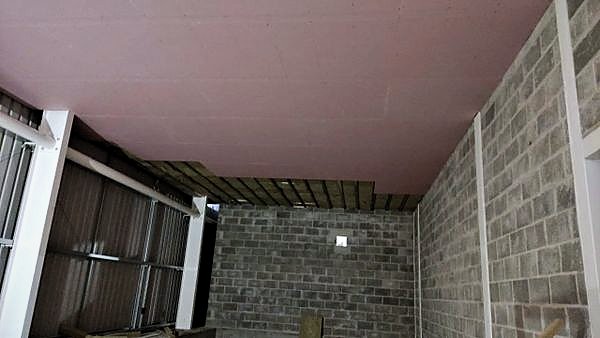 Plasterboard ceiling installed over blockwork walls
