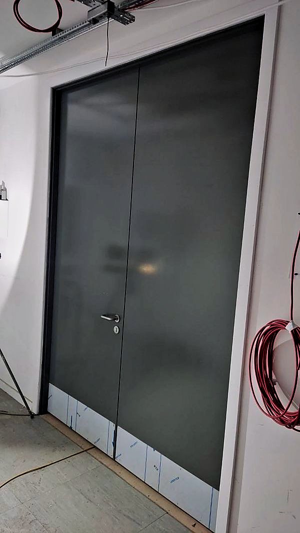 Grey finished double doors with protective film still at the base
