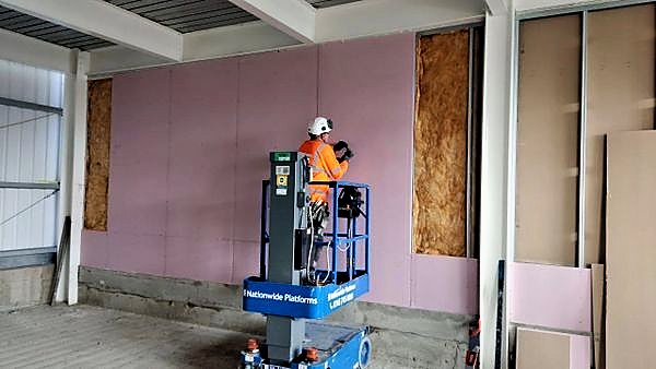 Boarding a full-height stud wall from a powered access platform