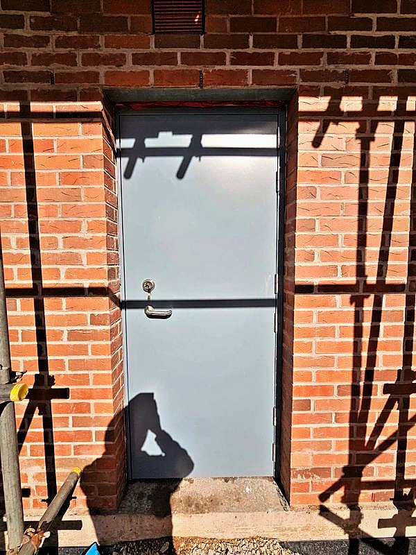 Steel personnel door set in new facing brickwork