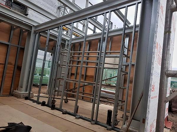Light-gauge steel wall framing with plywood facings and an access tower