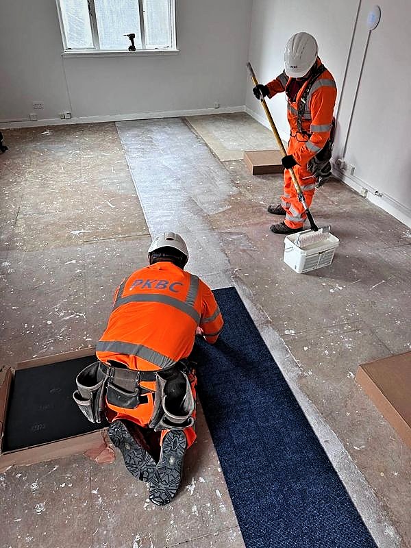 PKBC operatives laying carpet tiles during a refurbishment